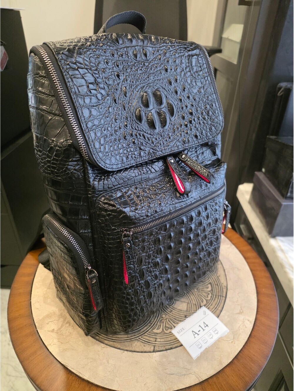 Black Croc-Embossed Backpack with Flap Closure and Red Zipper Pulls